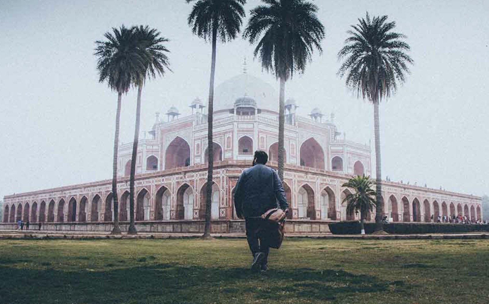 A person walking towards Humayun's Tomb