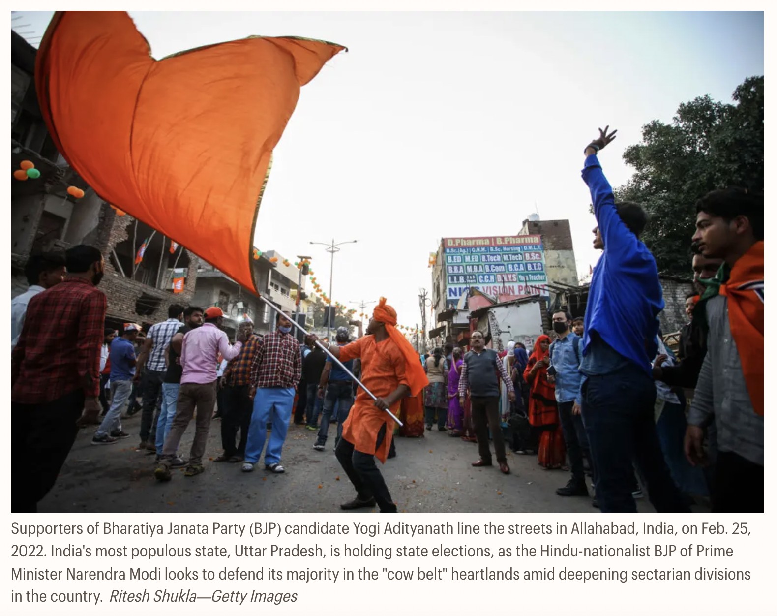 Supporters of BJP candidate Yogi Adityanath lining the streets in Allahabad, India