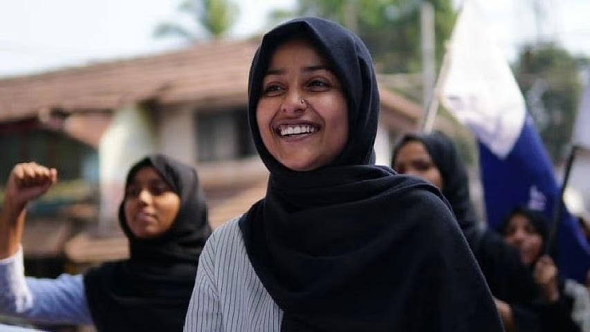Afreen Fatima smiling while wearing a hijab at a protest