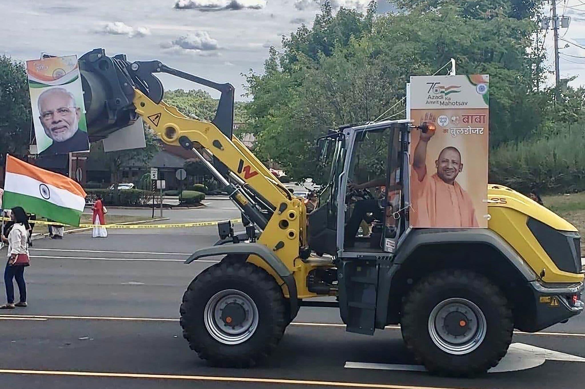 A yellow bulldozer decorated with Indian political posters at a New Jersey parade